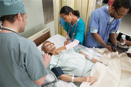 Medical Team Treating Patient Stock Photo - Premium Royalty-Free, Code: 600-01235396