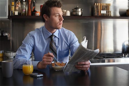 simsearch:700-00515127,k - Man Reading Newspaper During Breakfast Stock Photo - Premium Royalty-Free, Code: 600-01235445