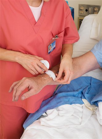 simsearch:600-01248237,k - Nurse Administering Intravenous to Patient Stock Photo - Premium Royalty-Free, Code: 600-01248235
