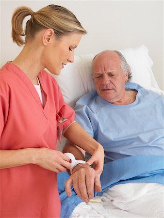 simsearch:600-01248237,k - Nurse Administering Intravenous to Patient Stock Photo - Premium Royalty-Free, Code: 600-01248236