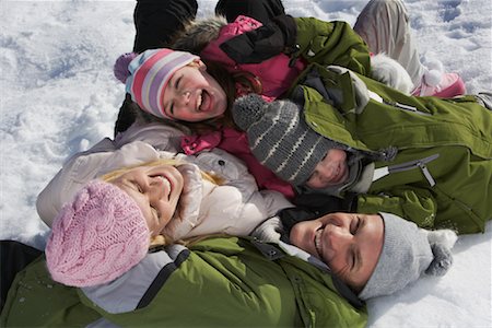 simsearch:600-01224168,k - Family Lying on Snow Stock Photo - Premium Royalty-Free, Code: 600-01248335
