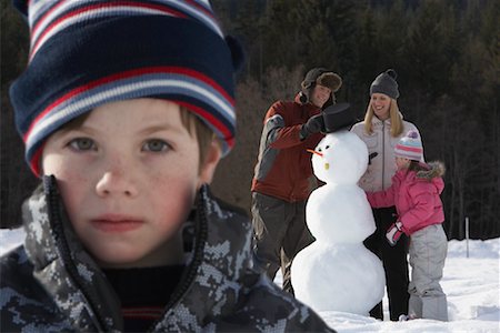 simsearch:600-01717666,k - Portrait of Boy, Family Making Snowman in Background Stock Photo - Premium Royalty-Free, Code: 600-01248349