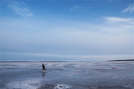 Boy Skating on Frozen Lake Stock Photo - Premium Royalty-Free, Code: 600-01248837