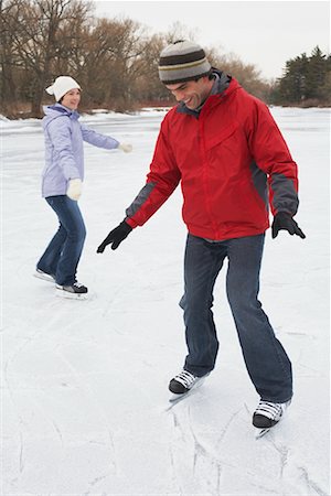Woman with Man Learning to Skate Stock Photo - Premium Royalty-Free, Code: 600-01249374
