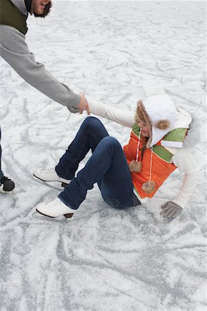 Man Helping Woman Up from Ice Stock Photo - Premium Royalty-Free, Code: 600-01249417