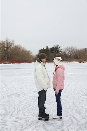 Couple Looking at Each Other on Ice Rink Stock Photo - Premium Royalty-Free, Code: 600-01249418