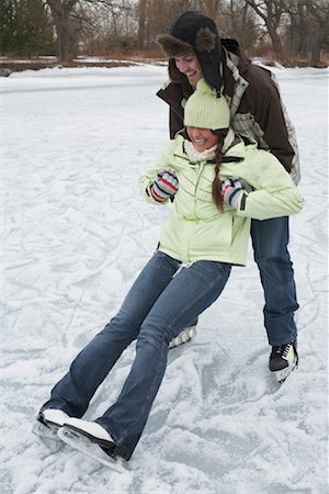 Man Catching Woman while Skating Stock Photo - Premium Royalty-Free, Code: 600-01249412