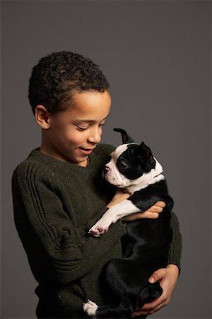 Little Boy Holding Dog Stock Photo - Premium Royalty-Free, Code: 600-01275401