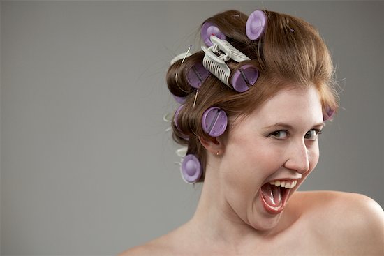 Curled Hair With Rollers. Woman with Curlers in Hair