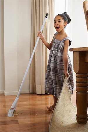 plaid skirt - Girl Sweeping Dirt under Rug Stock Photo - Premium Royalty-Free, Code: 600-01276400