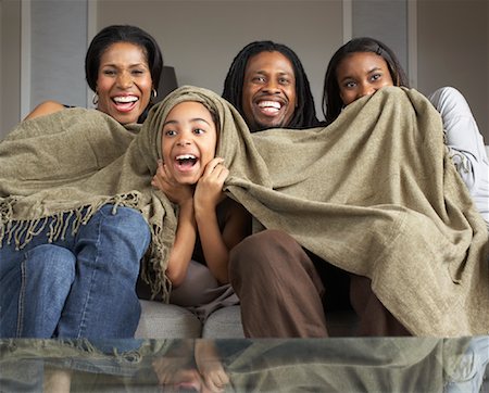 Family Watching Television Together Stock Photo - Premium Royalty-Free, Code: 600-01276427