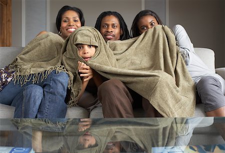 Family Watching Television Together Stock Photo - Premium Royalty-Free, Code: 600-01276428