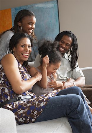 Family on Living Room Sofa Stock Photo - Premium Royalty-Free, Code: 600-01276420