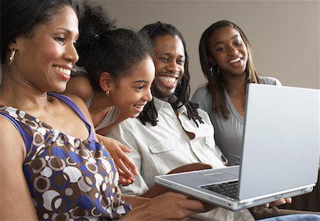 simsearch:600-01072265,k - Family on Living Room Sofa with Laptop Computer Foto de stock - Sin royalties Premium, Código: 600-01276423