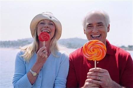 Portrait of Couple Eating Lollipops Stock Photo - Premium Royalty-Free, Code: 600-01296378