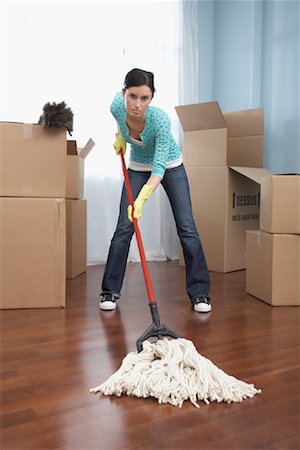 Woman with Mop and Feather Duster in New Home Stock Photo - Premium Royalty-Free, Code: 600-01345134