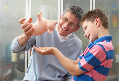 Father and Son With Piggy Bank Stock Photo - Premium Royalty-Free, Code: 600-01374093