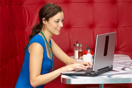 Woman with Laptop in Restaurant Stock Photo - Premium Royalty-Free, Code: 600-01407147