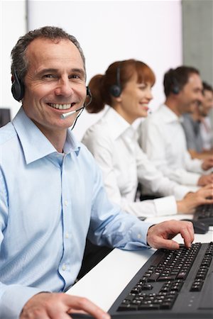 Business People Working at Computers with Headsets Stock Photo - Premium Royalty-Free, Code: 600-01464429