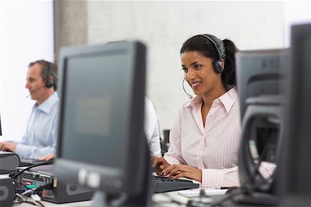 simsearch:700-01248091,k - Business People Working on Computers with Headsets Stock Photo - Premium Royalty-Free, Code: 600-01464448