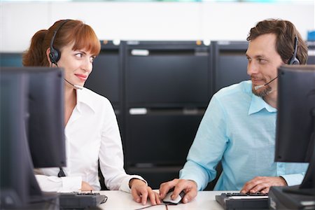 Business People Working on Computers with Headsets Stock Photo - Premium Royalty-Free, Code: 600-01464456
