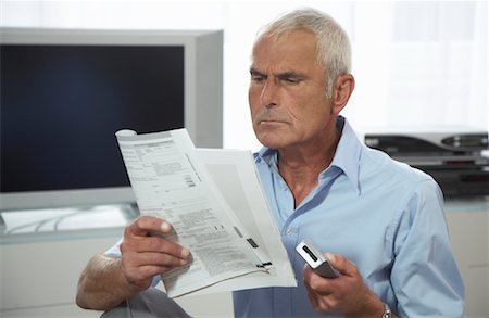 Man Looking at Instruction Manual Stock Photo - Premium Royalty-Free, Code: 600-01575662