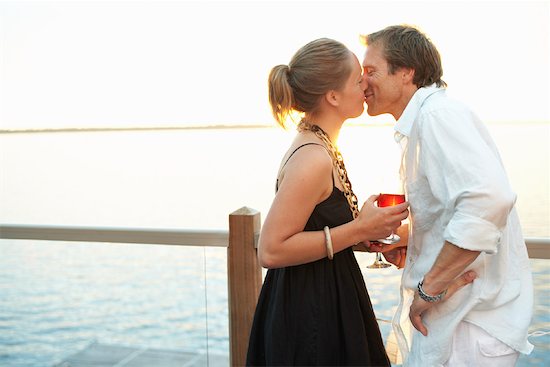 couple kissing sunset. Couple Kissing by the Lake at