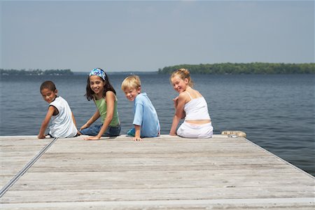 Children Sitting on Dock Stock Photo - Premium Royalty-Free, Code: 600-01585918