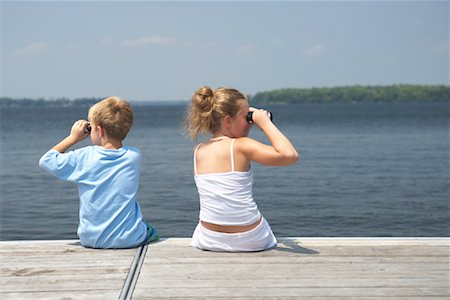 Boy and Girl Sitting on Dock Stock Photo - Premium Royalty-Free, Code: 600-01585929