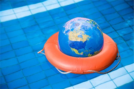 simsearch:700-00618429,k - Globe in Life Preserver in Pool Stock Photo - Premium Royalty-Free, Code: 600-01586908