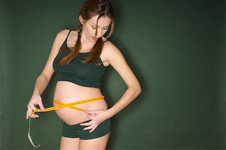 simsearch:600-01296088,k - Pregnant Woman Measuring Stomach Stock Photo - Premium Royalty-Free, Code: 600-01605949