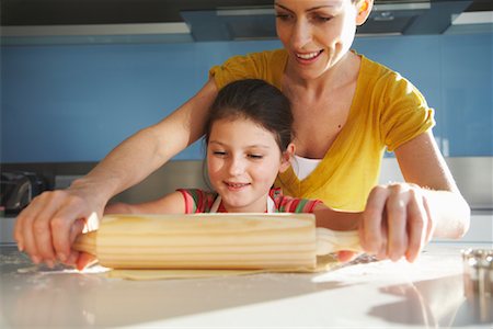 stretching (extended object) - Mother and Daughter Rolling Cookie Dough Stock Photo - Premium Royalty-Free, Code: 600-01606633