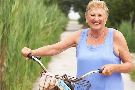 riding bike with basket - Portrait of Woman With Bicycle Stock Photo - Premium Royalty-Free, Code: 600-01606785
