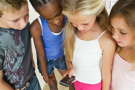 simsearch:700-00606683,k - Kids Reading Text Messages on Cell Phone Stock Photo - Premium Royalty-Free, Code: 600-01603916