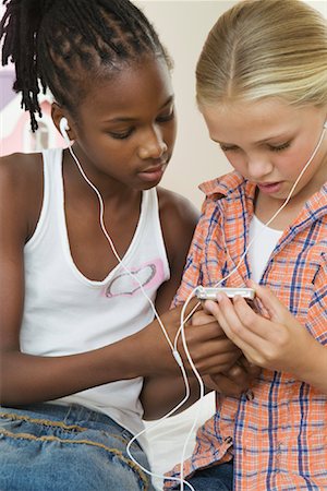 Girls Listening to MP3 Player Stock Photo - Premium Royalty-Free, Code: 600-01603922