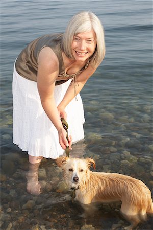 Woman With Dog in Water Stock Photo - Premium Royalty-Free, Code: 600-01616648