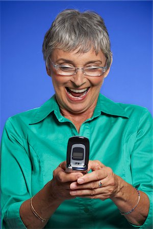 senior women chat - Woman Reading Text Message Stock Photo - Premium Royalty-Free, Code: 600-01613593