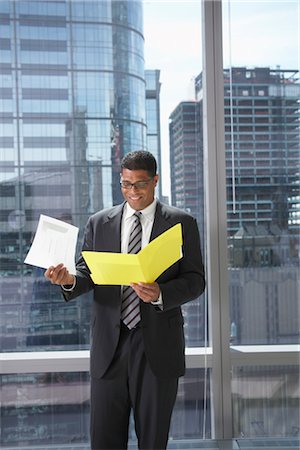 simsearch:600-01613965,k - Businessman with File Folder Stock Photo - Premium Royalty-Free, Code: 600-01613940