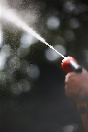 Man Holding Hose Stock Photo - Premium Royalty-Free, Code: 600-01644883