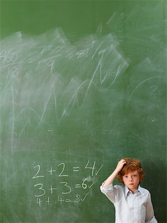Boy Standing at Blackboard Stock Photo - Premium Royalty-Free, Code: 600-01646286