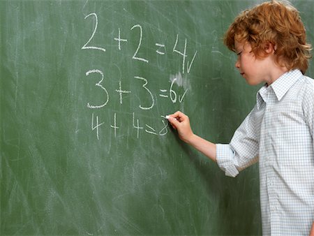 Boy Writing on Blackboard Stock Photo - Premium Royalty-Free, Code: 600-01646288