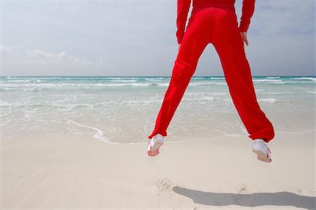 simsearch:700-02913016,k - Woman Jumping on the Beach Stock Photo - Premium Royalty-Free, Code: 600-01694029