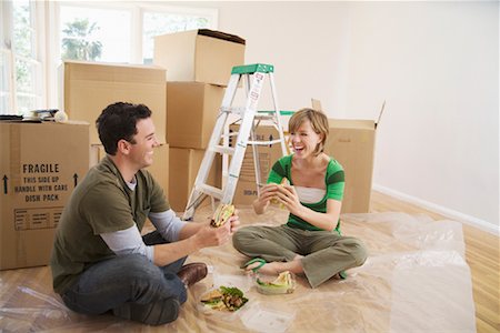 simsearch:600-01073479,k - Couple Eating Sandwiches in New Home Stock Photo - Premium Royalty-Free, Code: 600-01694109