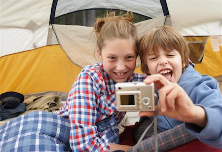 Brother and Sister Taking Picture in Tent Stock Photo - Premium Royalty-Free, Code: 600-01694191