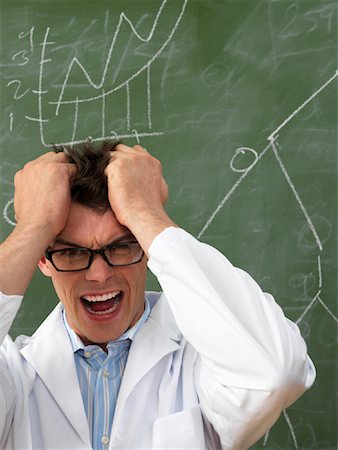 Confused Scientist in Front of Blackboard Stock Photo - Premium Royalty-Free, Code: 600-01695338