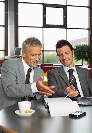 pictures of business people on their blackberry - Businessmen Looking at Document Stock Photo - Premium Royalty-Free, Code: 600-01695546