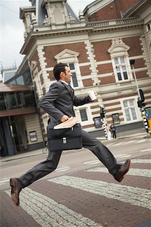 drinking coffee in paper cups - Man Running Across Street, Amsterdam, Netherlands Stock Photo - Premium Royalty-Free, Code: 600-01695551