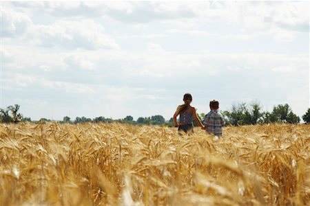 Brother and Sister Running through Grain Field Stock Photo - Premium Royalty-Free, Code: 600-01716066