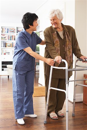 Senior Woman Receiving Assistance with Using Walker Stock Photo - Premium Royalty-Free, Code: 600-01716134