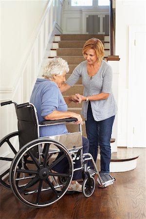 Senior Woman in Wheelchair Receiving Assistance Stock Photo - Premium Royalty-Free, Code: 600-01716154